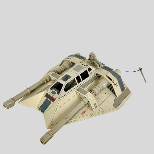 A beige and gray plastic model of a futuristic tank vehicle, from Star Wars.