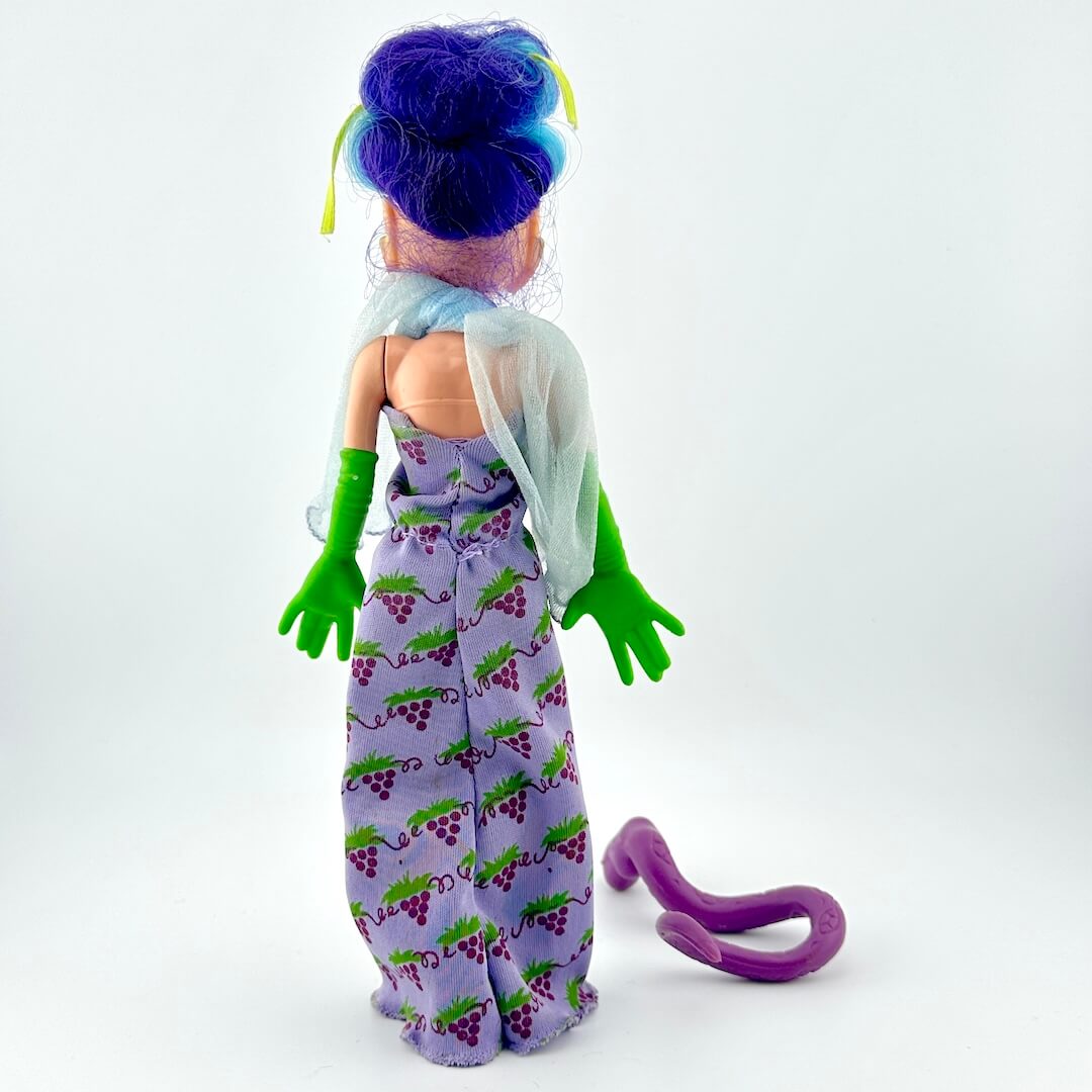 Toy figure with purple hair and green gloves on a white background