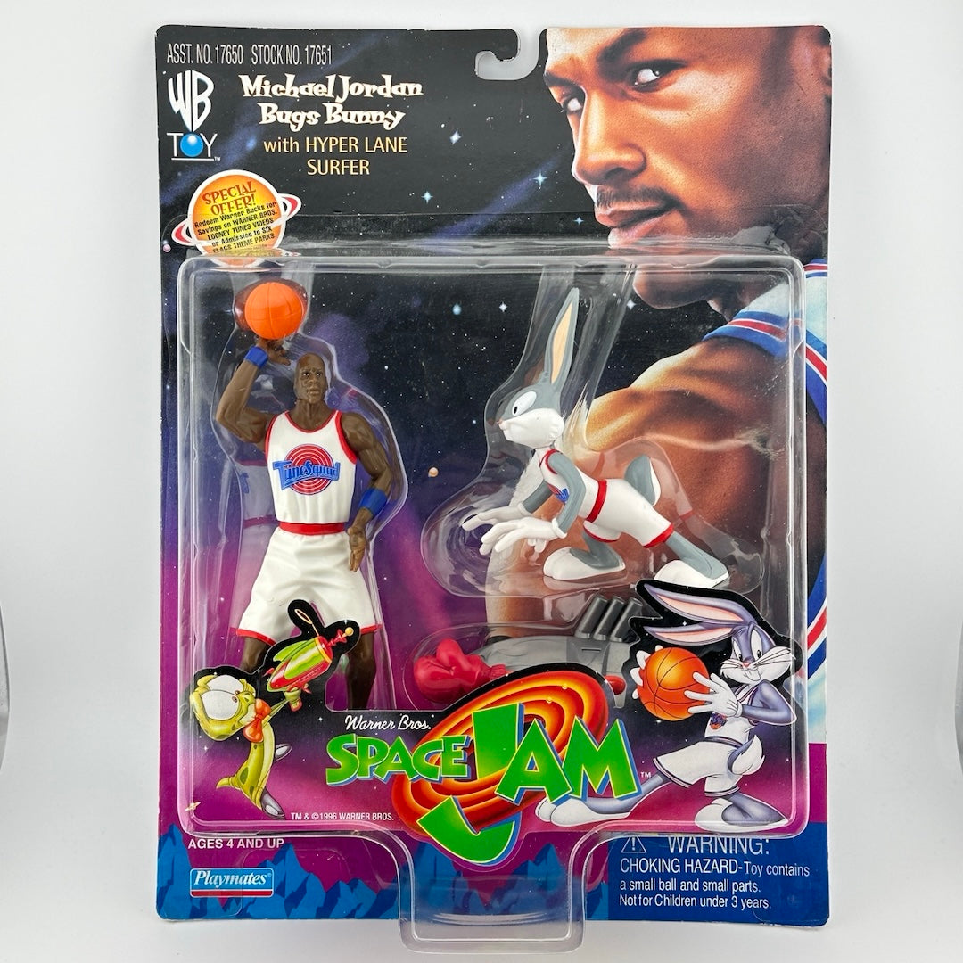 Michael Jordan & Bugs Bunny action figures dressed in white basketball uniforms with picture of Jordan on backing.