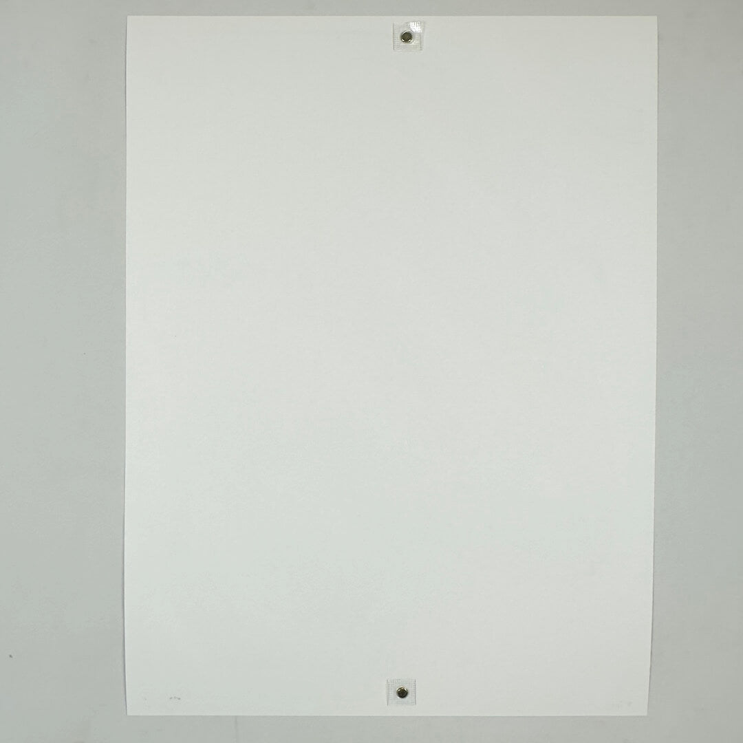 Backside of white poster against white background.