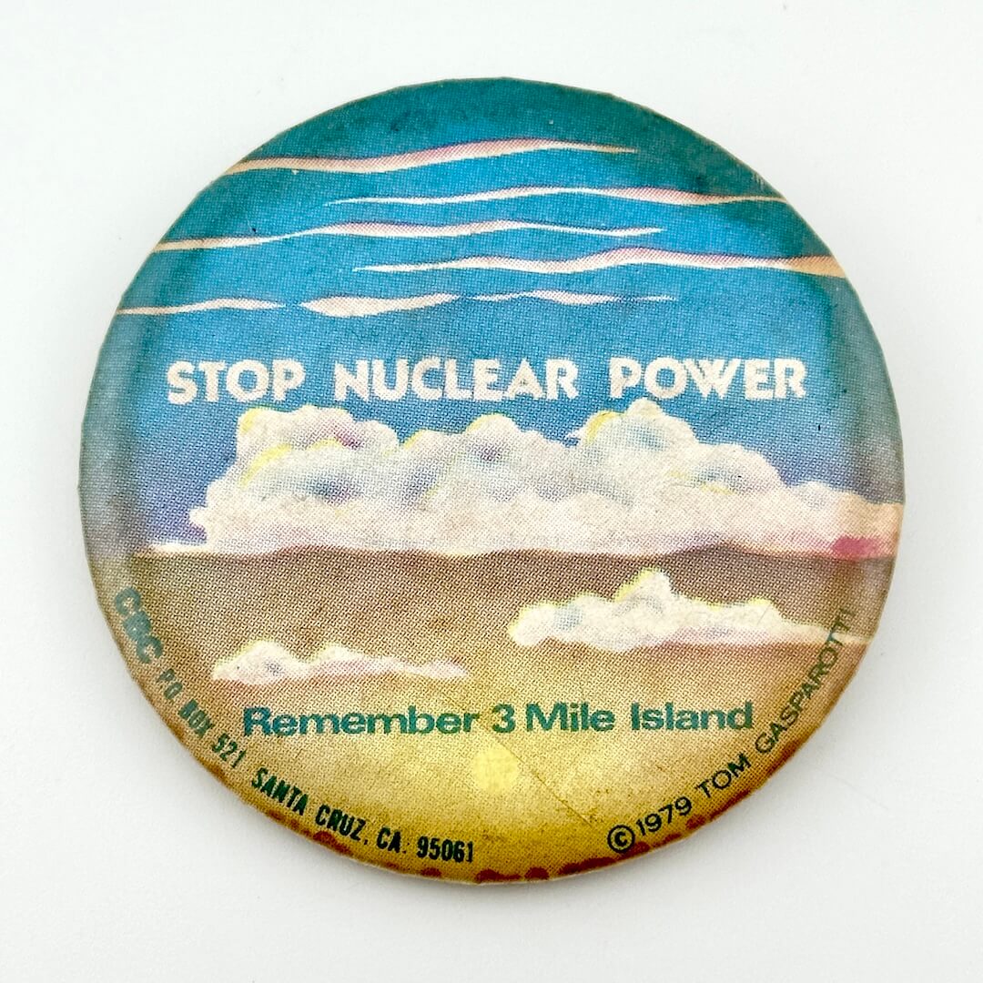 Circular pin with clouds and text, "Stop Nuclear Power, Remember 3 Mile Island."