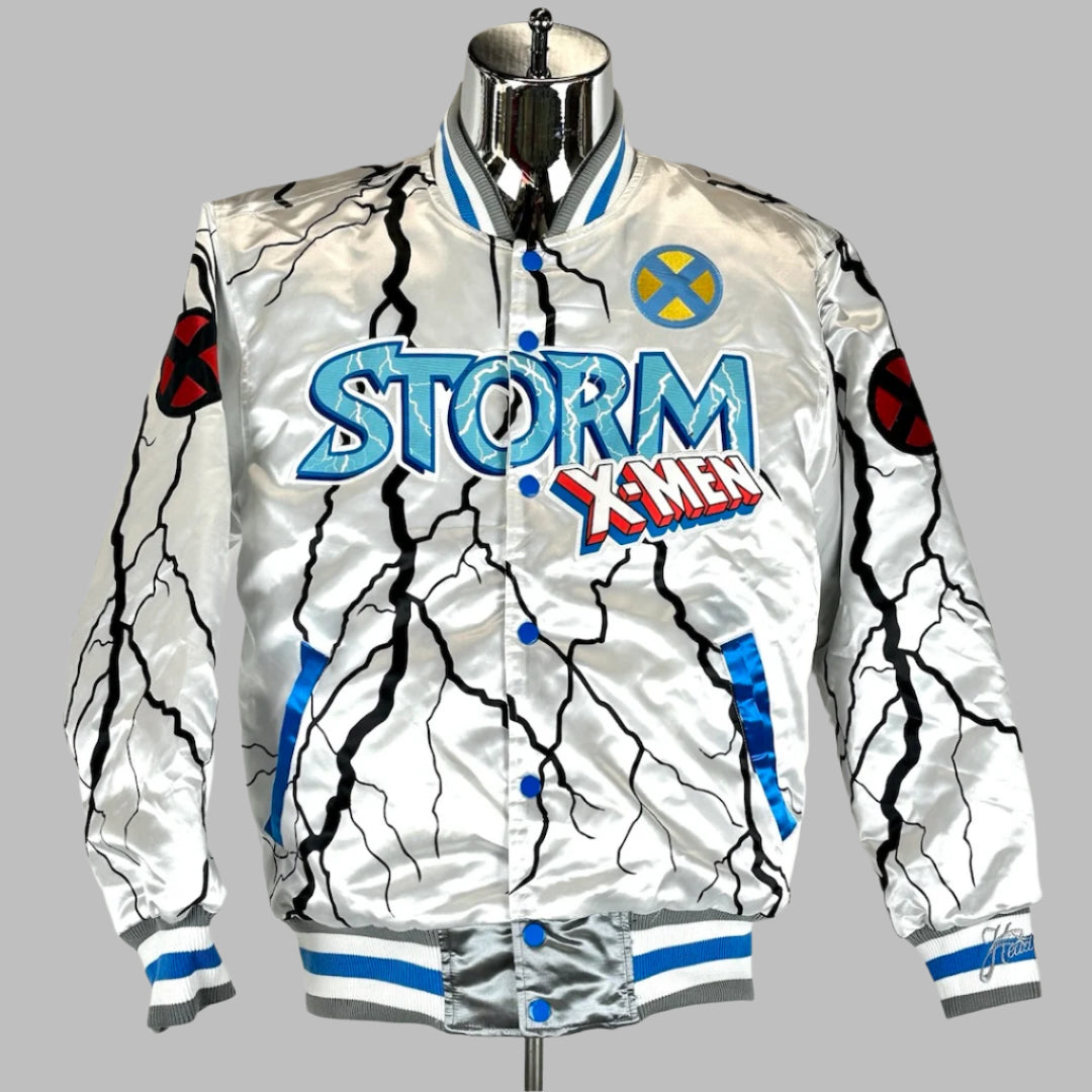 silver jacket with blue Storm font and X-men logo on chest. Black lightning with blue pocket trim.