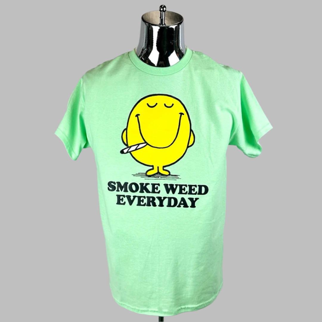 Sea-foam green short sleeved tee. Yellow smiling emoji person hands behind back, smoking a joint. "Smoke Weed Everyday" below