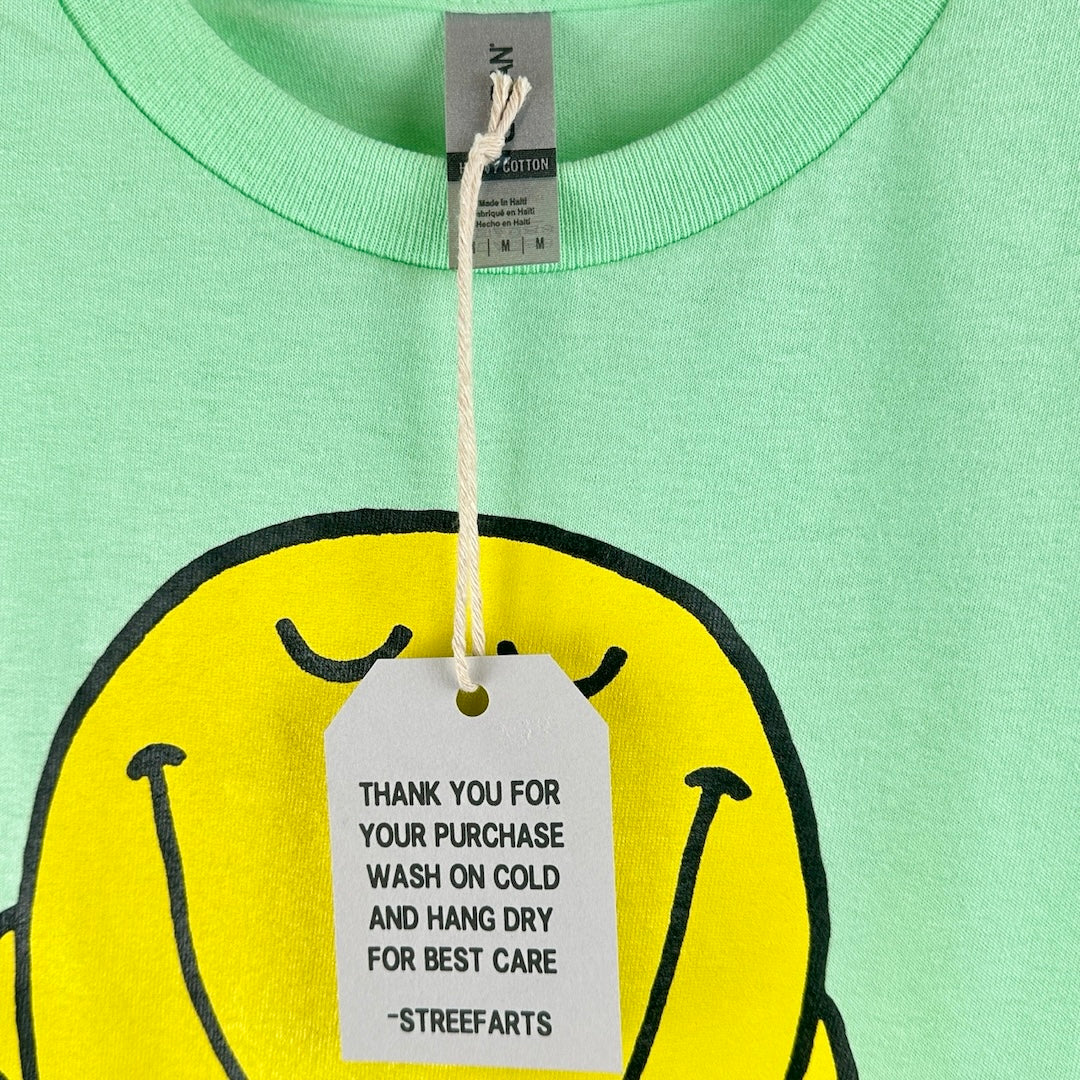 Close up of tag with size info, shirt material & care instructions,.