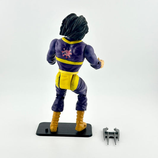 Action figure in a blue and yellow costume with a red emblem on a white background