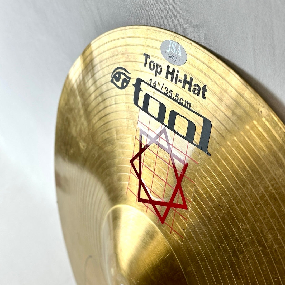 White JSA authentication sticker with TOOL lettering and Red square design logo below