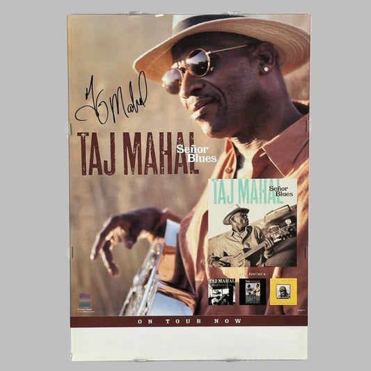 Poster for Señor Blue album by Taj Mahal with image of him playing guitar at right, his name & signature at left.
