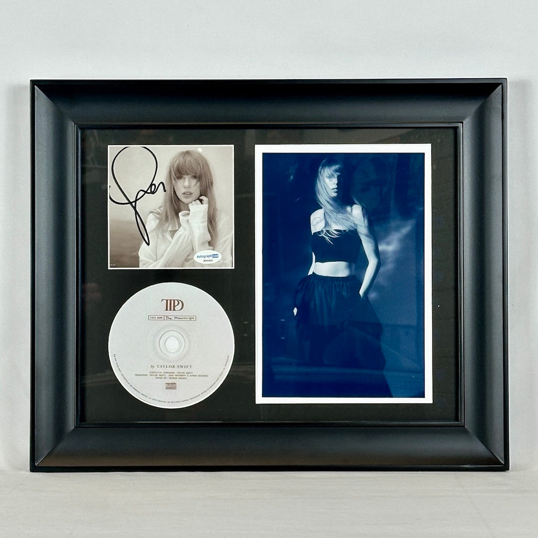 Framed B & W picture of Taylor Swift with signed booklet & CD. Booklet has signature on cover with Taylor picture behind.