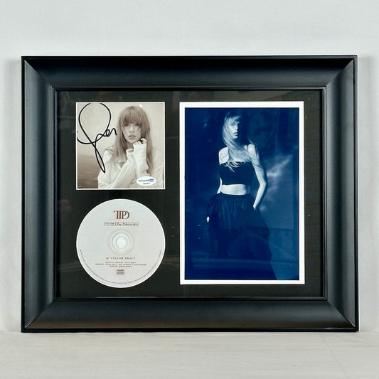 Framed B & W picture of Taylor Swift with signed booklet & CD. Booklet has signature on cover with Taylor picture behind.