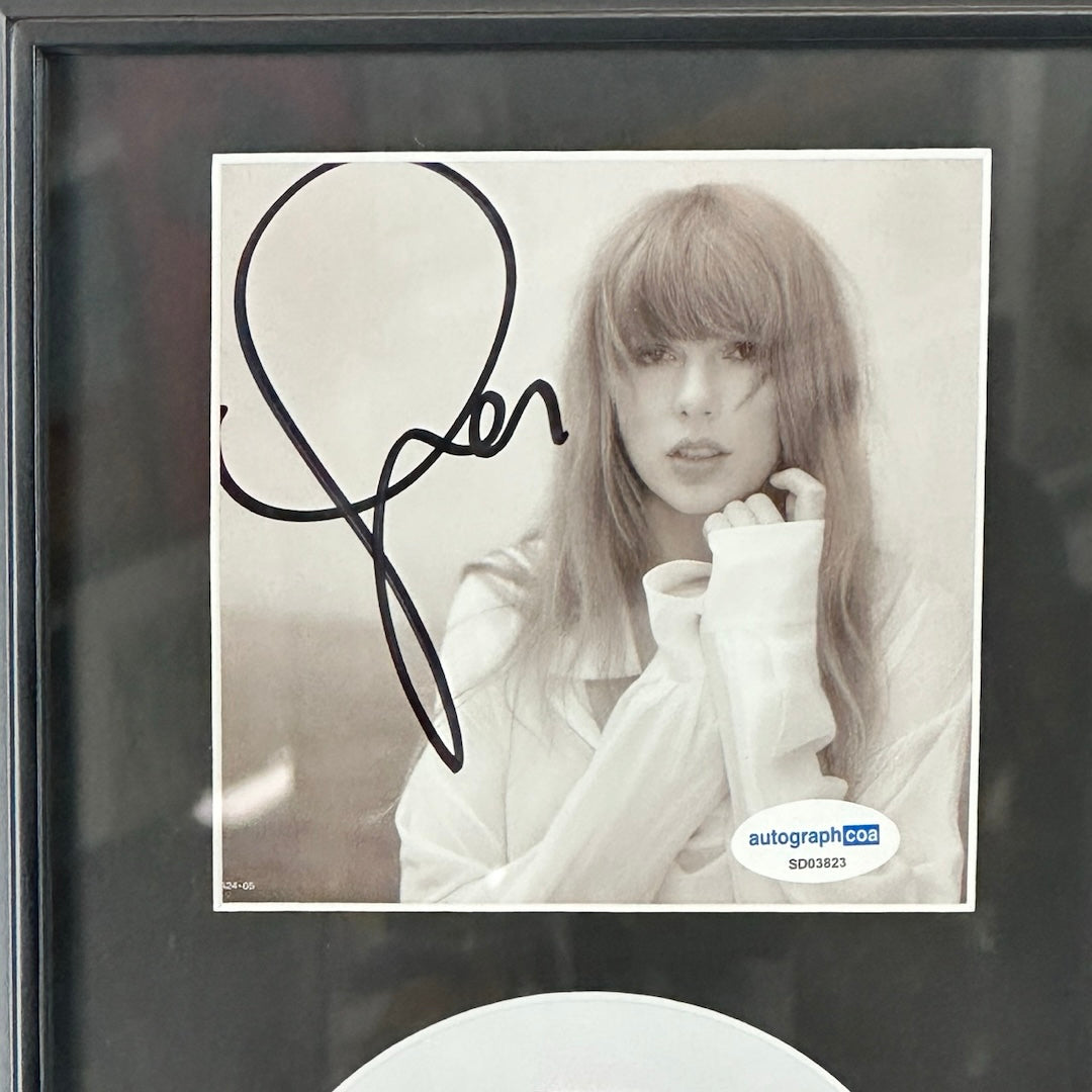 CD booklet of Taylor Swift in black and white. Signature in black on top left corner.