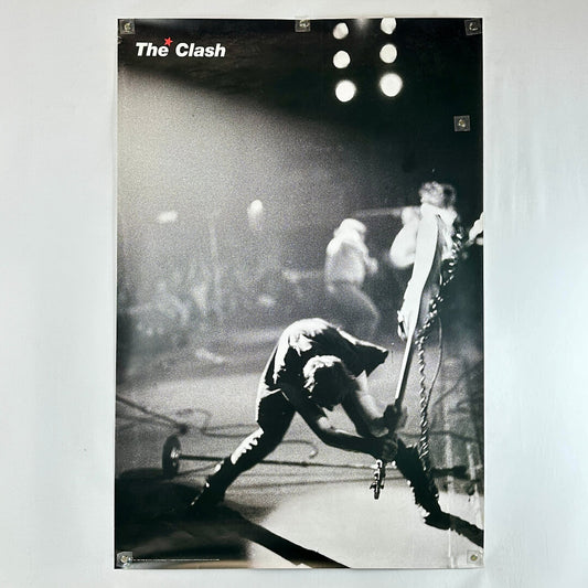 Poster of a band performing on stage with 'The Clash' logo.