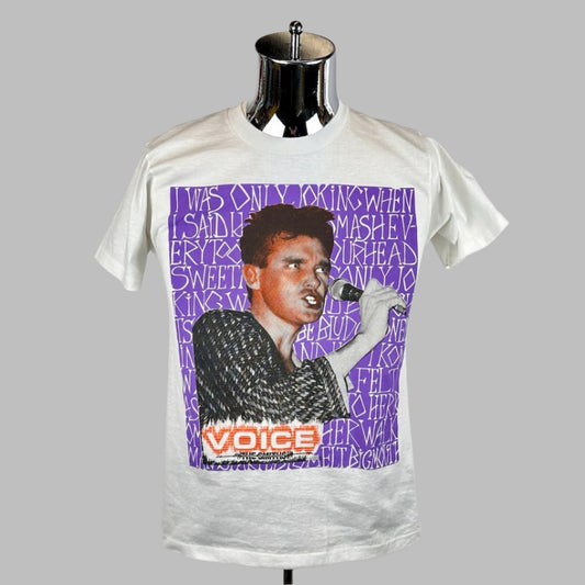 White short sleeve shirt with purple block background with white text, centered image of lead singer of The Smiths.