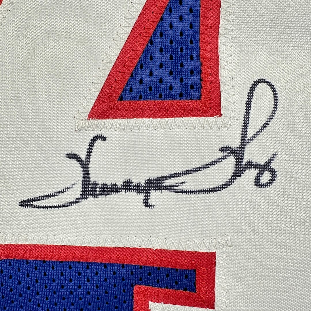 Embroidered number '4' with a signature on a sports jersey