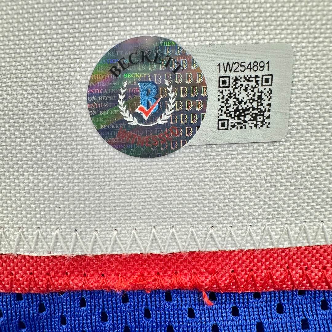 Close-up of a label with a logo and QR code on a textured fabric background