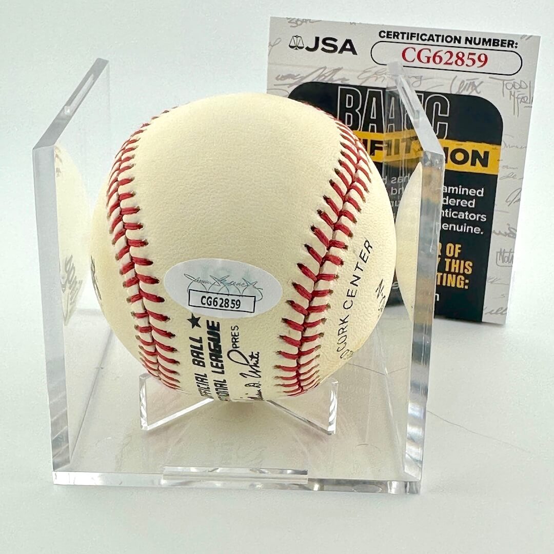 Baseball in a clear display case with JSA certification in the background