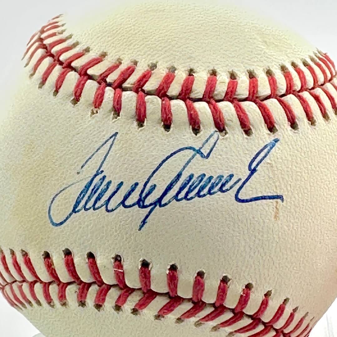 Baseball with a signature on a white background, close up of signature.