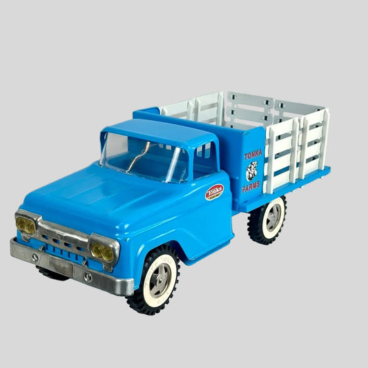 Blue toy truck with a white trailer on a light gray background