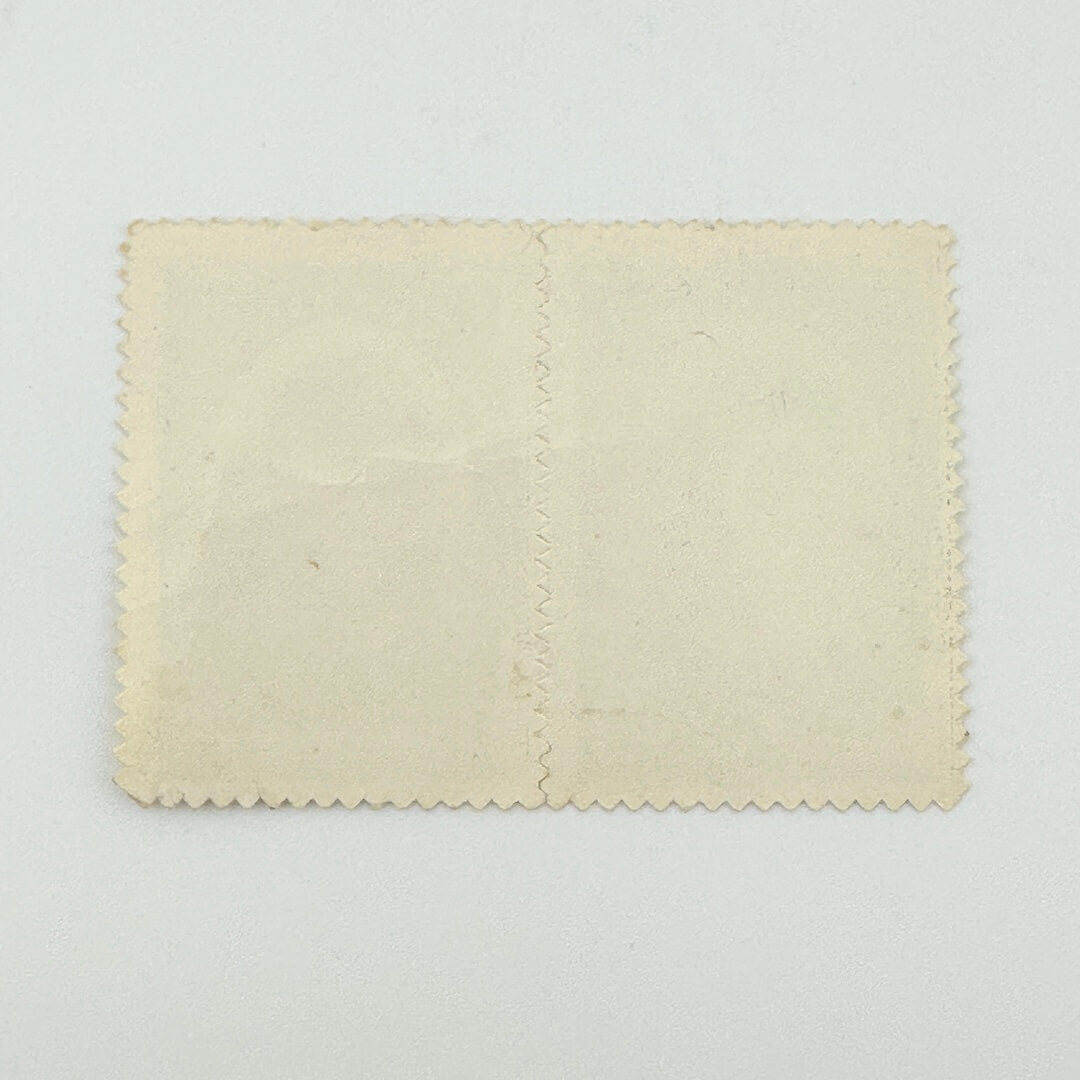 A blank, vintage-style cream-colored paper card with scalloped edges and a vertical center seam, displayed flat.