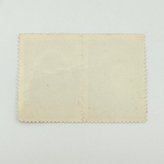 A blank, vintage-style cream-colored paper card with scalloped edges and a vertical center seam, displayed flat.