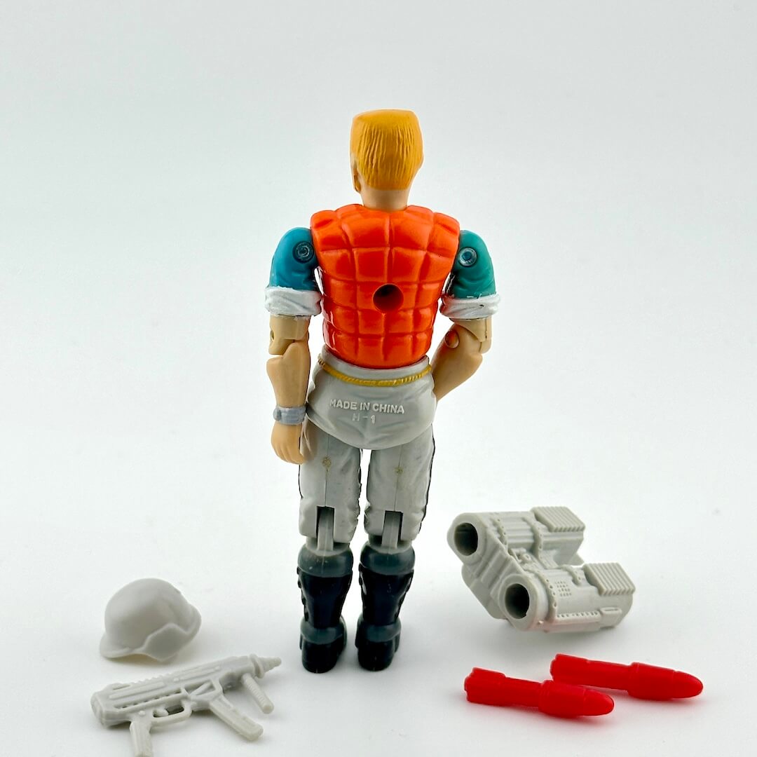 GI Joe action figure with accessories against white background.