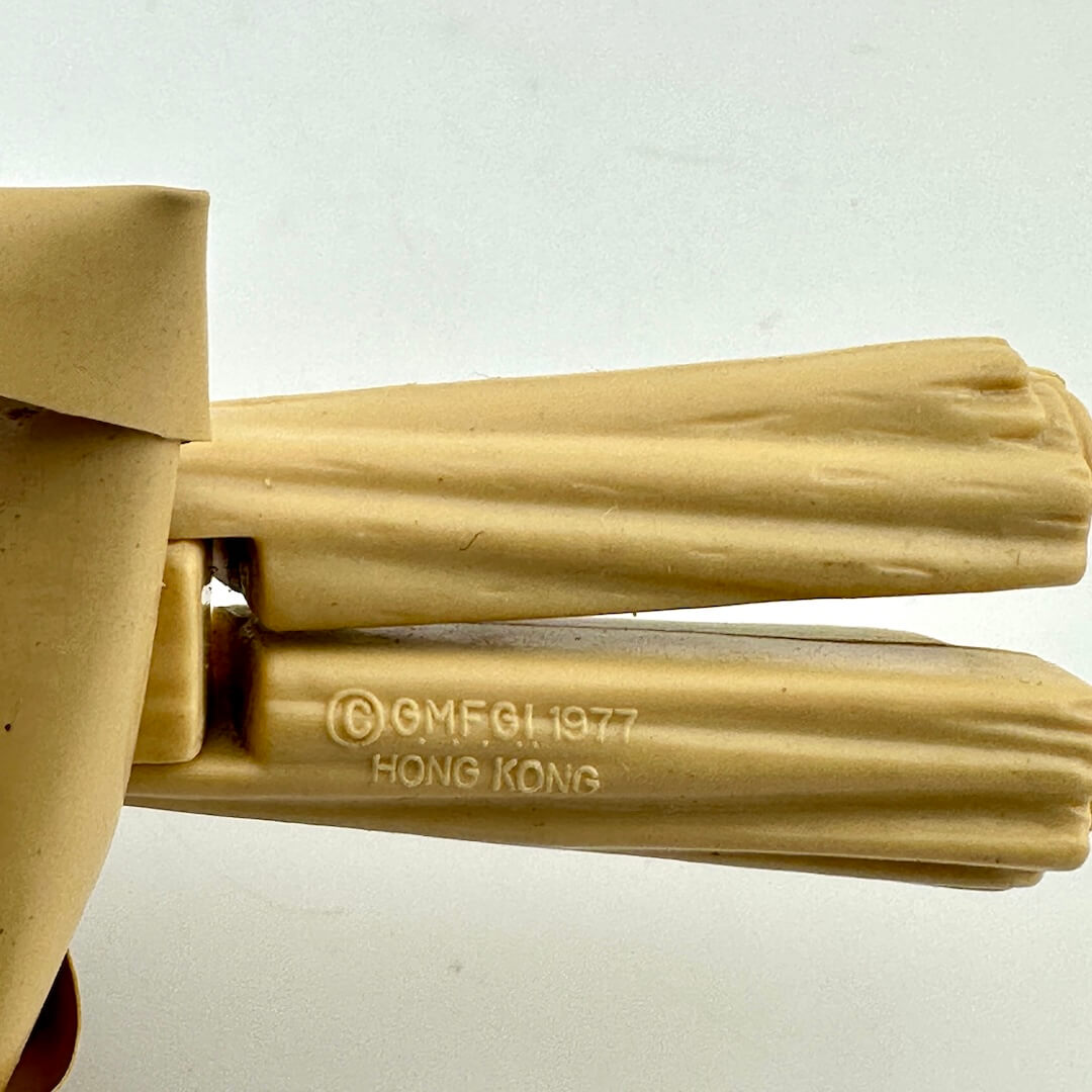Close-up of back of figure's legs with COO and copyright information.