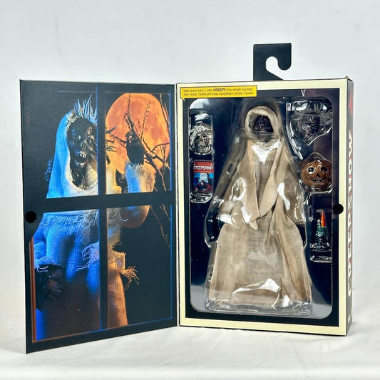 Action figure in packaging with promotional images on a white background