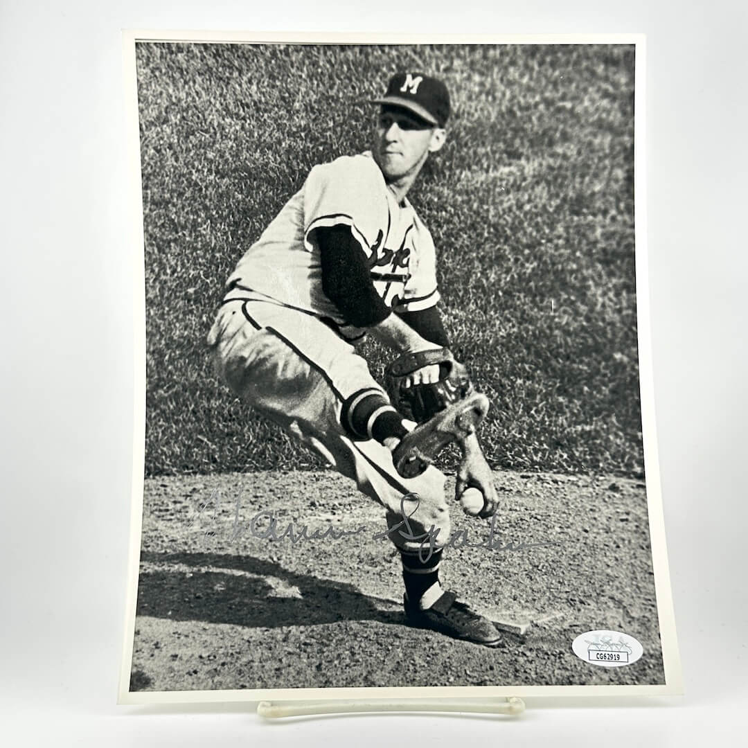 Black and white photo of a baseball player in action on a grass field