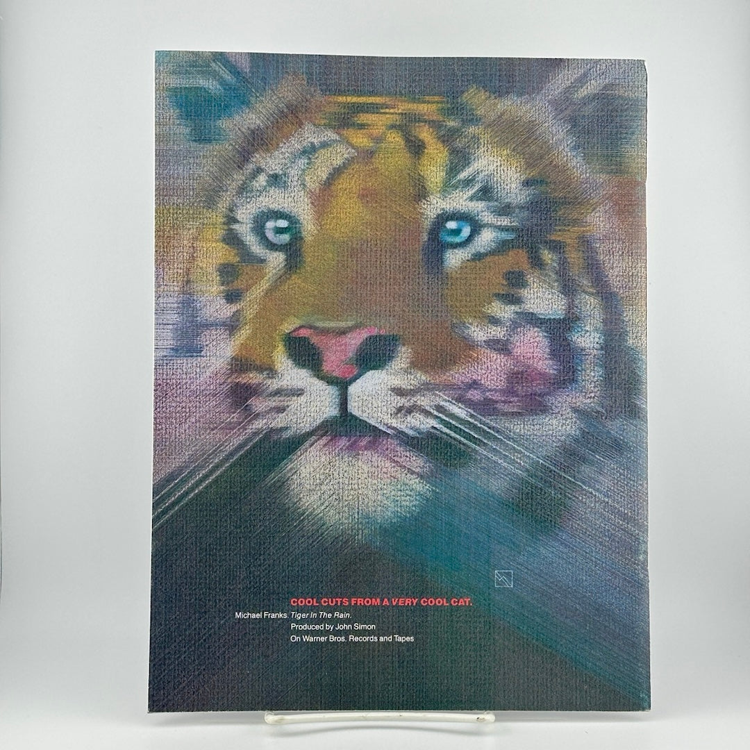 Art featuring tiger's face with corners brushed out to a fade, red/white text with related info below.