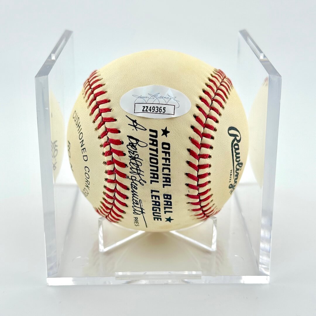 Signed baseball with Rawlings branding and JSA sticker in display cube against white background.