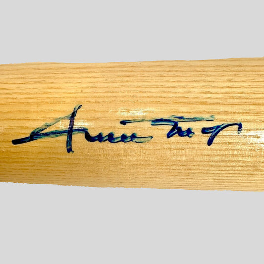 Wooden bat with a signature on a white background