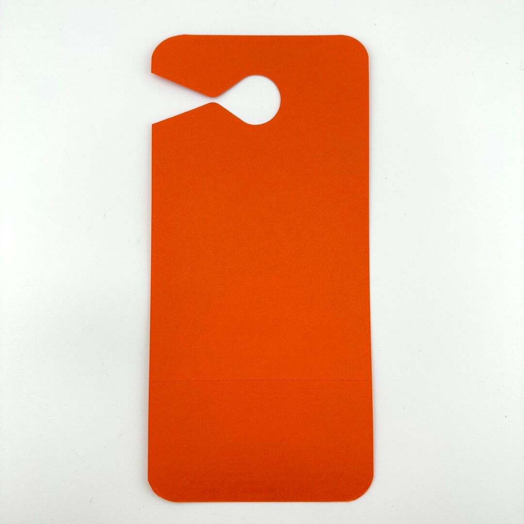 Orange door hanger shaped pass on a light gray background