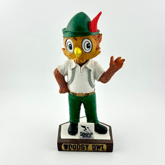 Bobblehead figure of an owl character in a green hat and outfit on a white background