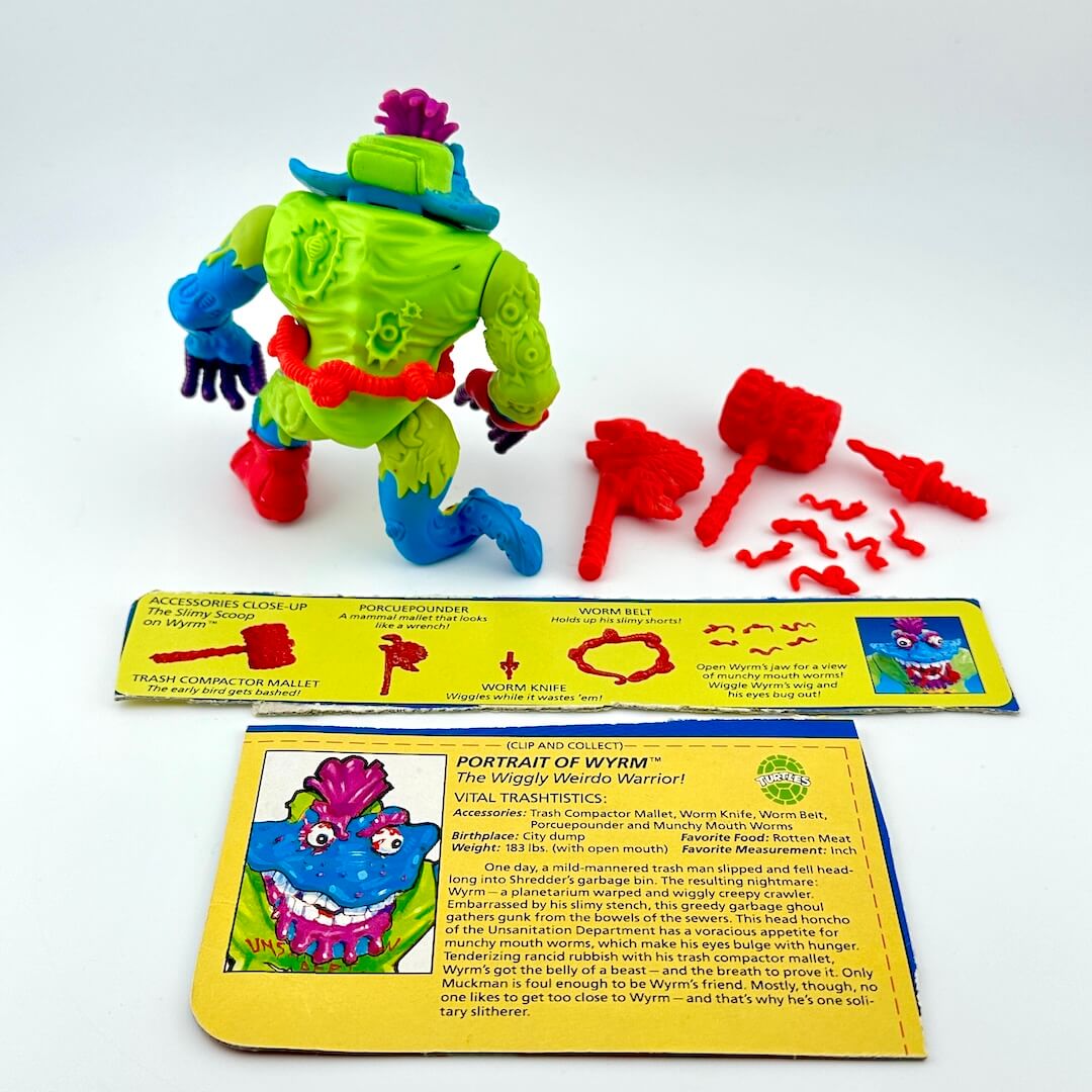 TMNT action figure with accessories and character card against white background.