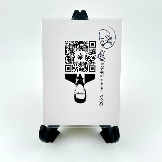 White card with black QR code and design on a black stand against a white background