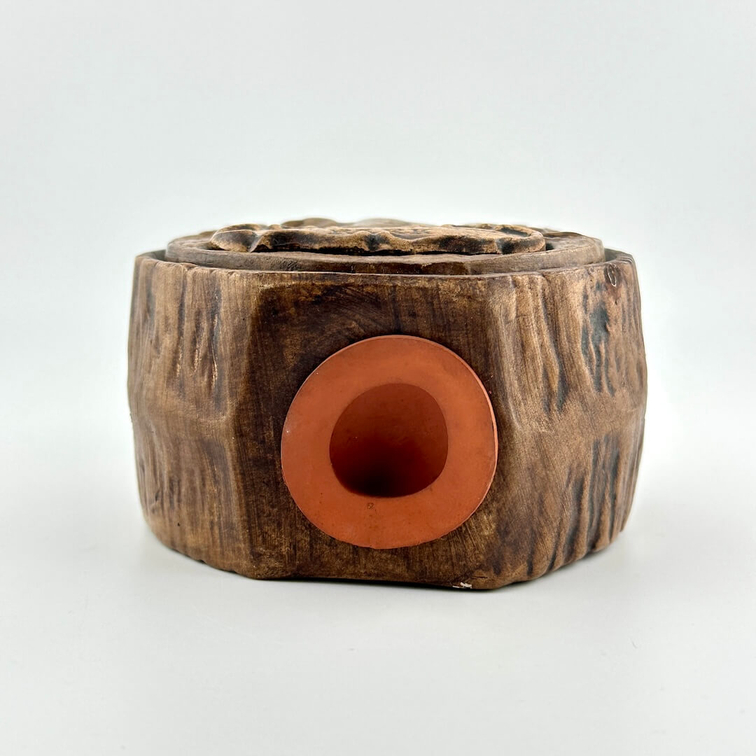 Bottom of bank with orange rubber plug in center.