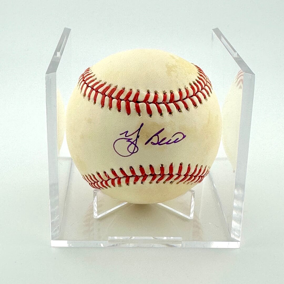 Signed baseball in clear display against white background.