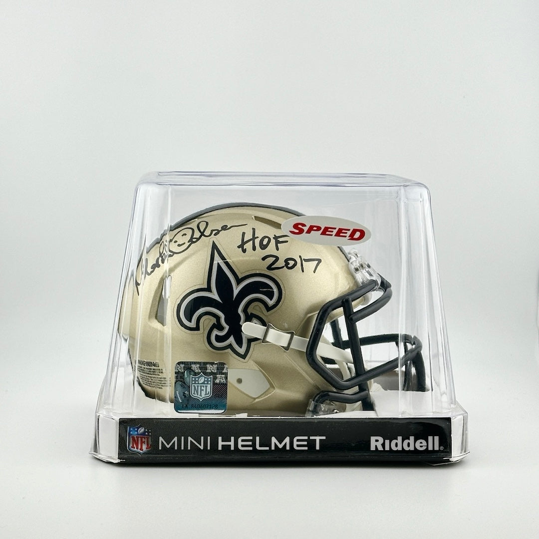 Gold mini helmet with Saints logo on side under black marker signature. In plastic packaging with official NFL sticker.