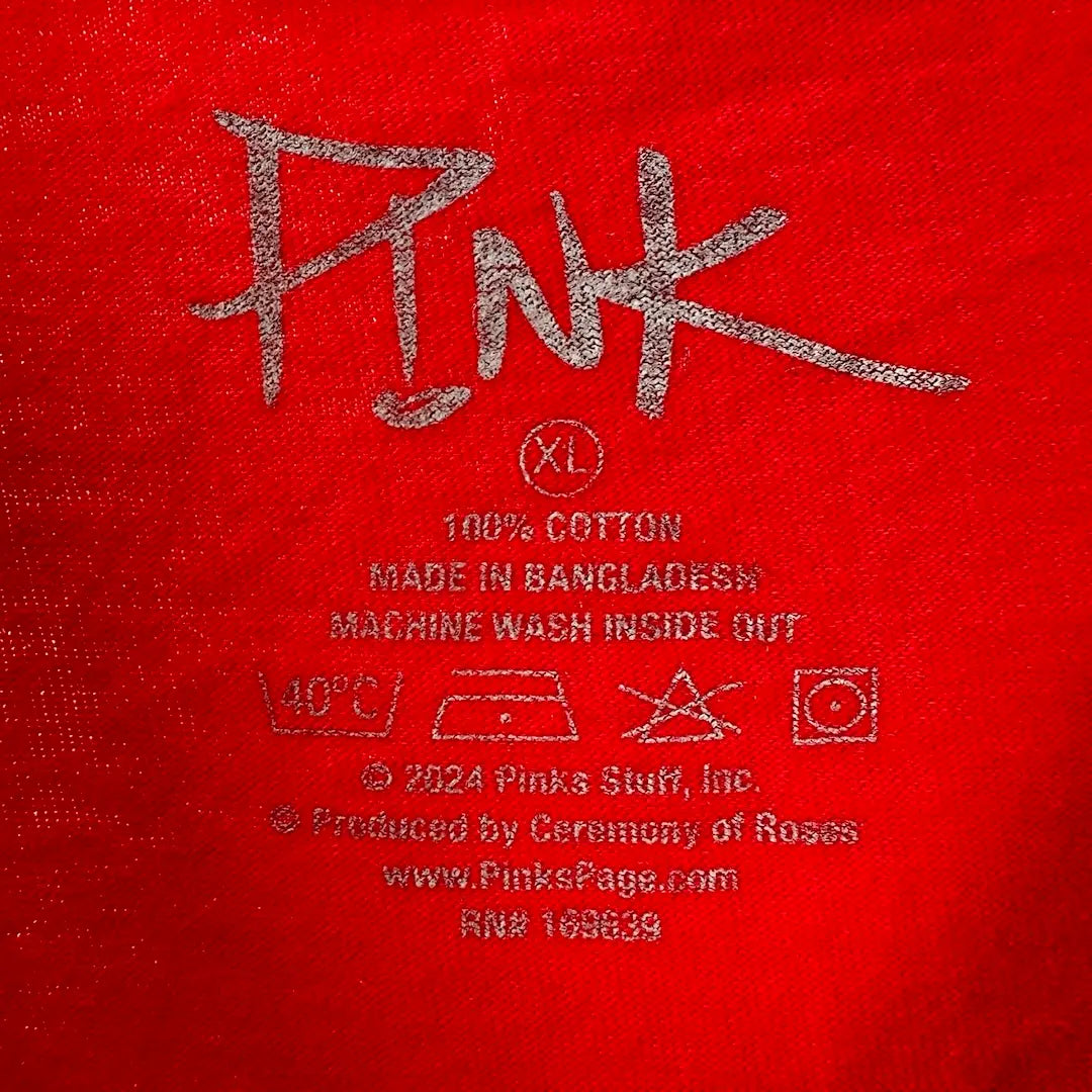 Close up of printed back neck tag showing p!nk logo, & info for material, care, size & copyright.