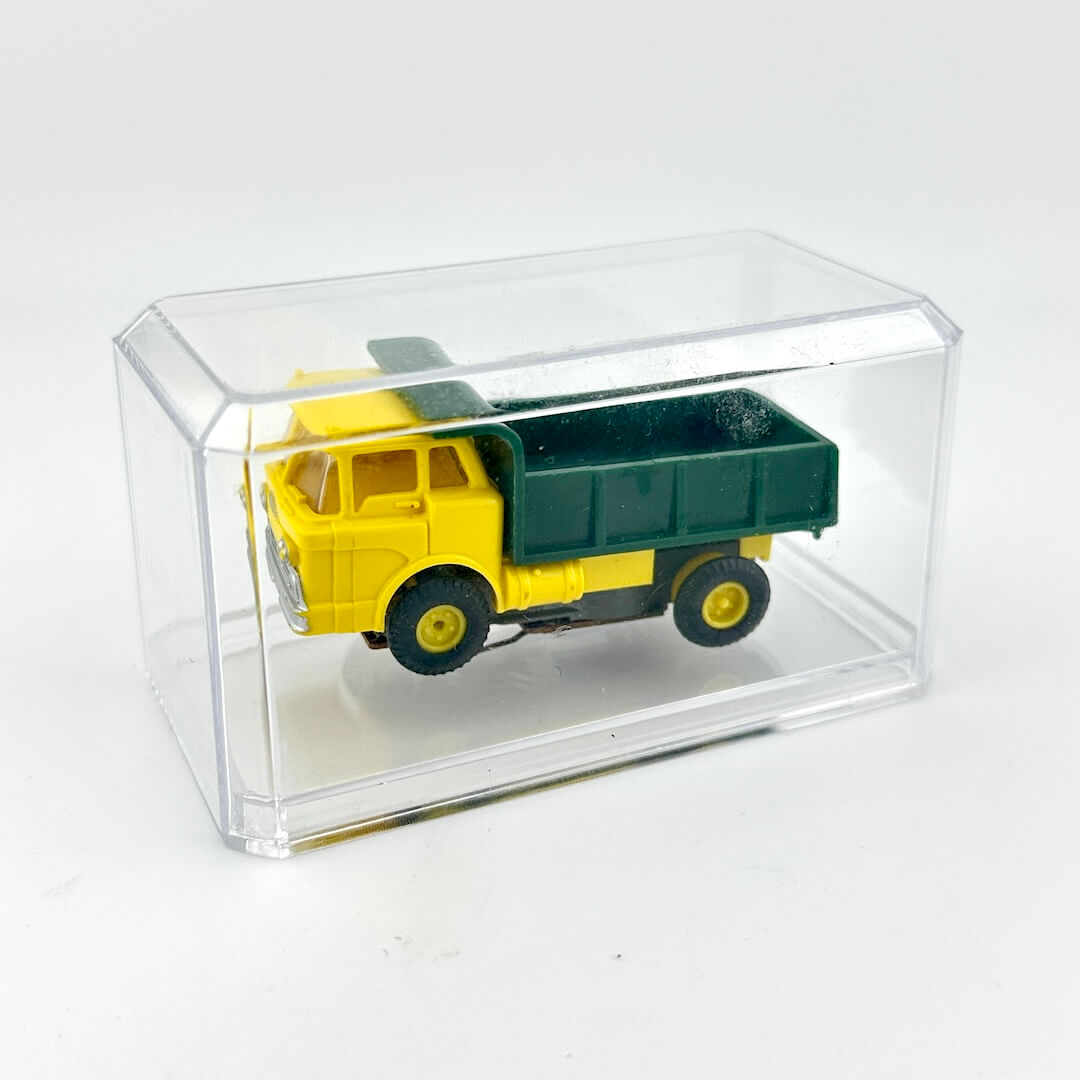 Model truck in a clear display case on a white background