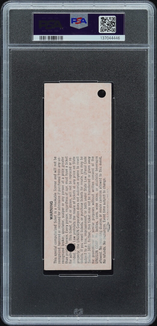 Plastic encased concert ticket with barcode and QR code on banner at top. 