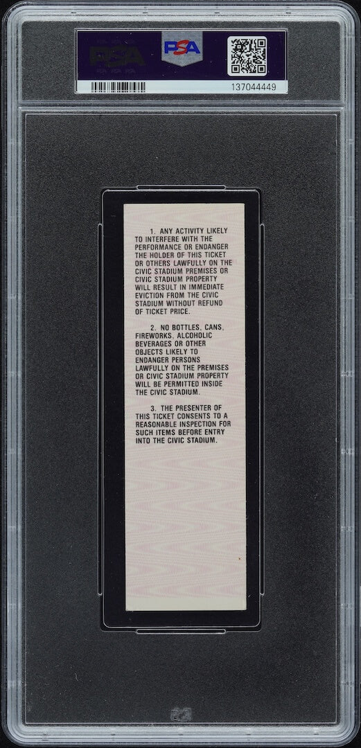 Backside of plastic encased event ticket with barcode and QR code on banner at top. 