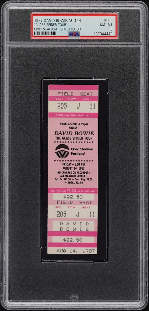 Plastic encased event ticket with barcode and information on banner at top. 