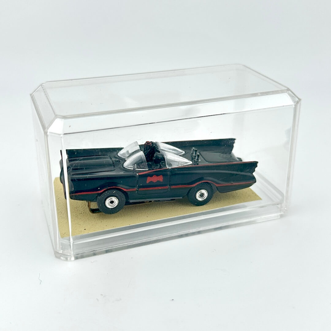 Model of the Batmobile in a clear display case on a white background