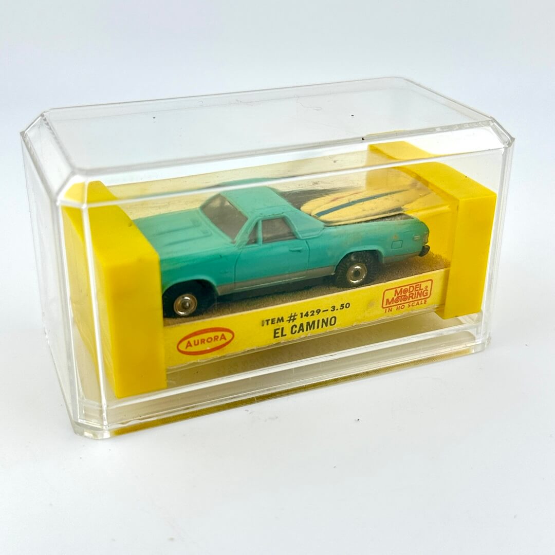 El Camino slot car in packaging against white background. 