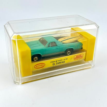 El Camino slot car in packaging against white background. 