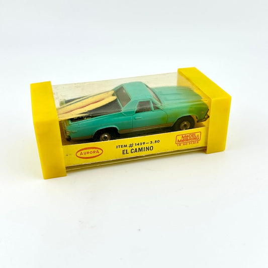 El Camino slot car in packaging against white background. 