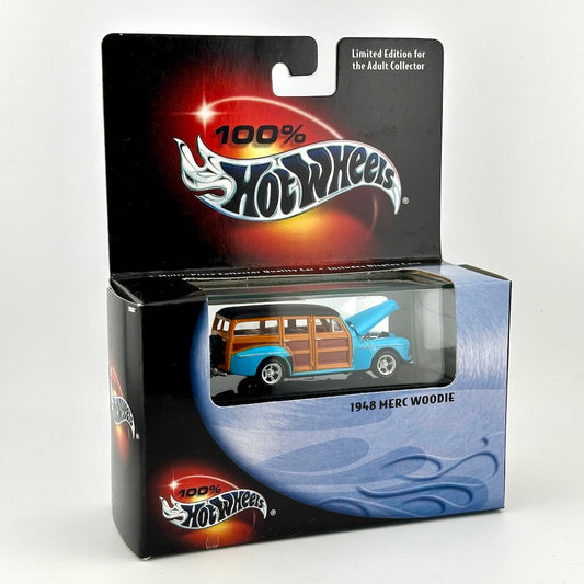 A Hot Wheels 1968 Merc Woodie diecast toy car in its original blister card packaging, featuring a blue car with wood panels. 