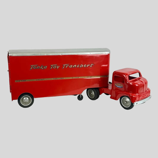 Red toy truck with trailer on a white background