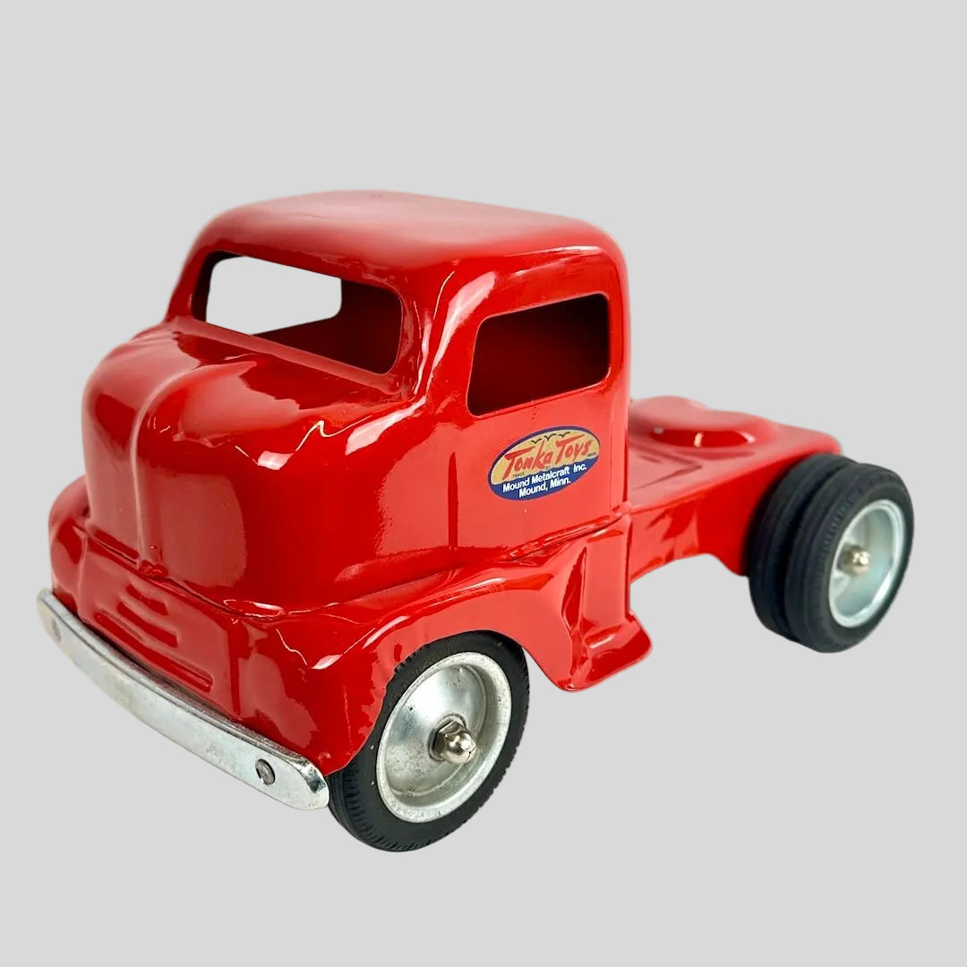 Red toy truck with a visible brand logo on a white background