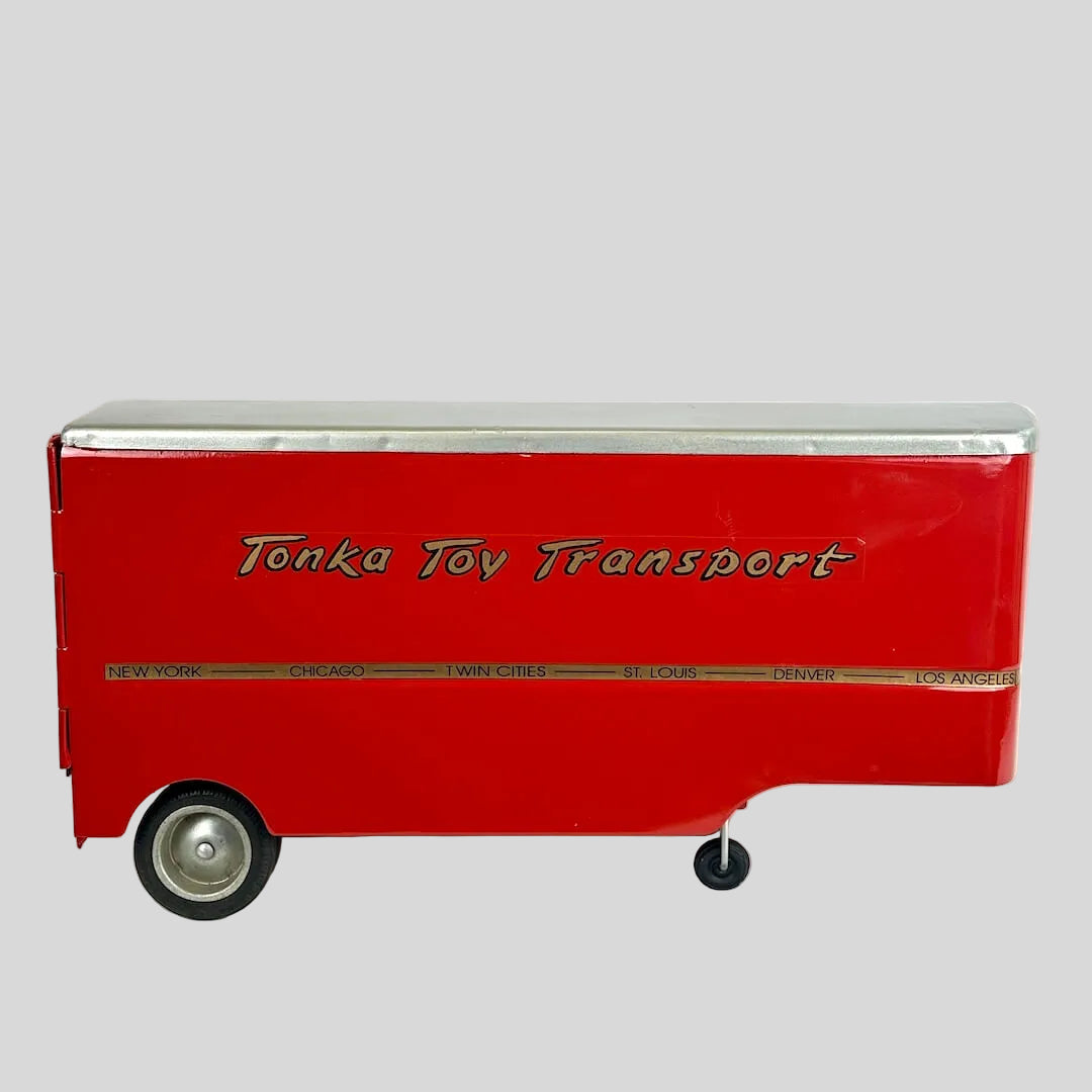 Red toy transport truck with 'Tonka Toy Transport' branding on a white background